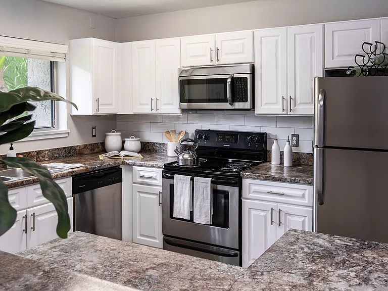 Cook in style with a fully equipped kitchen featuring stainless steel appliances, granite-style countertops, and ample cabinetry.