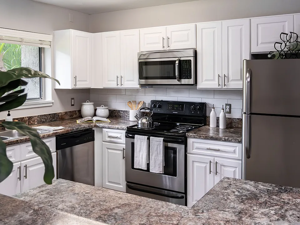Cook in style with a fully equipped kitchen featuring stainless steel appliances, granite-style countertops, and ample cabinetry.