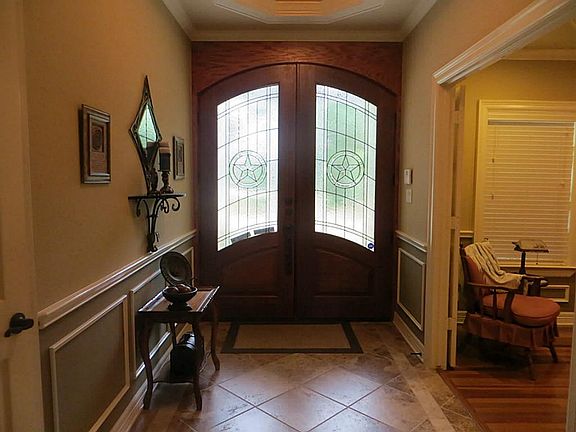 Entryway Has Double Texas Star Doors, Porcelain Tiles and Tiered Ceiling.