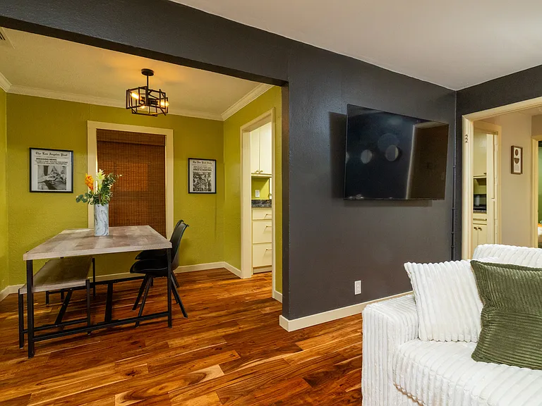 Open and inviting living room featuring a cozy couch, a ceiling fan for comfort, and fun colors that add character and flow.