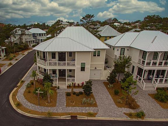 Ashley Lane front view of home with drive/garage entry. Hot water shower adjacent to the garage outside.