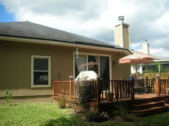 Fenced back yard with lovely deck.