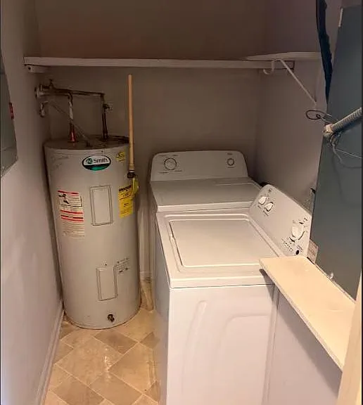 Dedicated laundry nook with full-size washer and dryer plus overhead shelving for detergents and supplies.