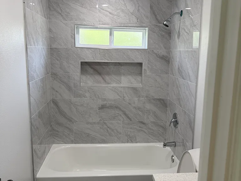 main bath, granite counters, bath tub, storage shelves