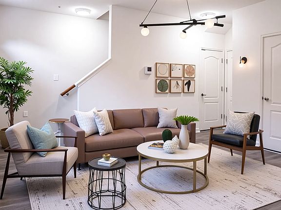 entry level living room/ rec room with half bathroom. Leading to attached garage