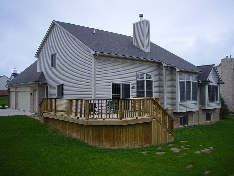Rear corner photo of deck and backyard.