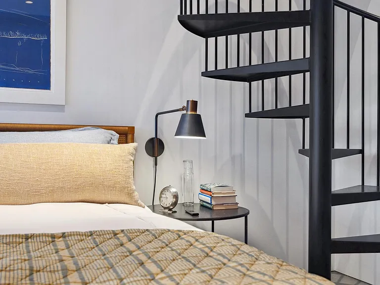 Close up of bed and stairs.