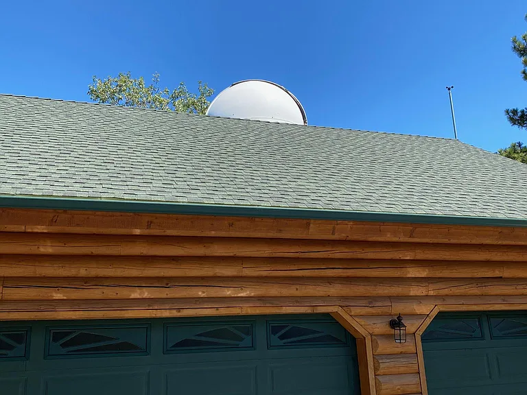 2 car garage with top of telescope showing.