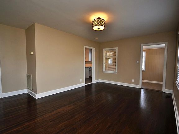 Spacious living room. Newly refinished hardwood floors and u