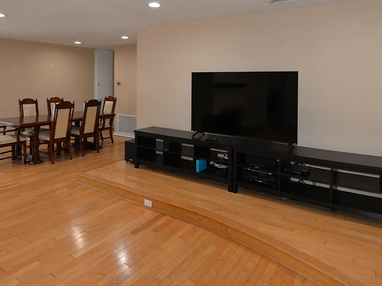 View from living room into Dining Area. A tv is shown here, but there is also a ceiling mounted projector that throws a 10 foot screen on this wall.