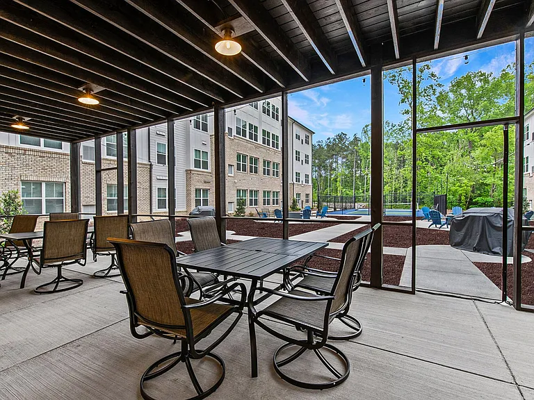 Active Adult apartments offer a patio with tables and chairs and a pickleball courts