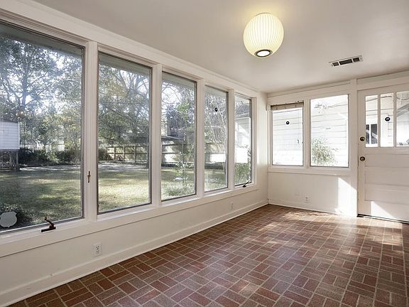 Light filled den with windows overlooking backyard.