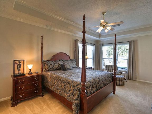 MASTER BEDROOM [17x20] This private retreat is features crown molding and a tall tray ceiling. Top of the line carpeting was installed in 2011 and is soft on your feet. The Sitting area overlooks your landscaped backyard with glorious lake views.