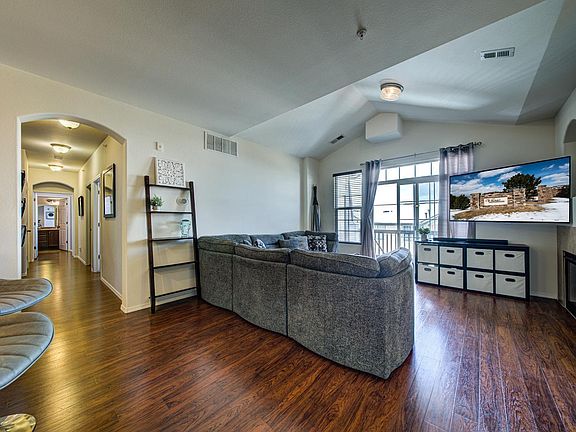 From breakfast island looking down the hall to bedrooms and to the living room. Note higher ceiling in living room.