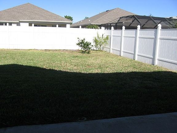 large back yard has PVC privacy fence.