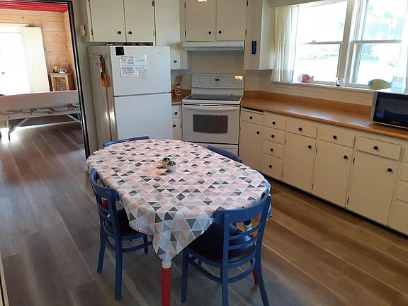 Large kitchen has ample storage, includes use of fridge, stove, microwave, coffee perk, all dishes and cutlery, etc.