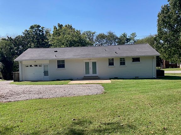 Back of house. Entrance to garage. French door to kitchen/dining.