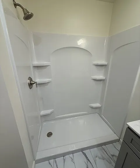 Sterling shower enclosure. Moen fixtures. Luxury vinyl plank flooring (looks like tile).
