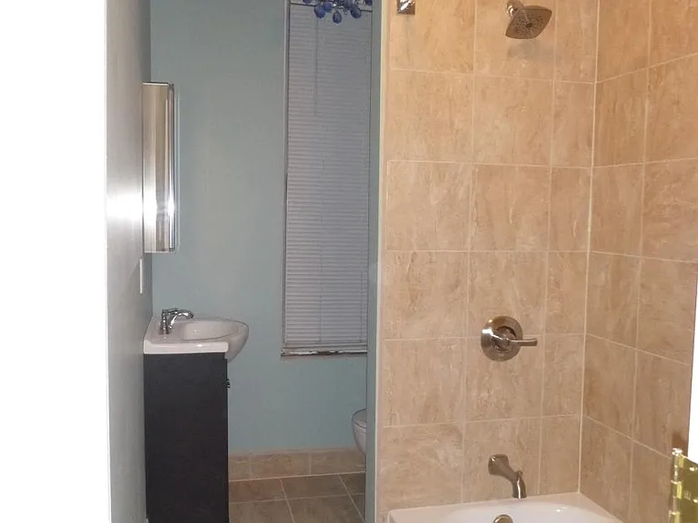 Tiled bathroom with Chandelier