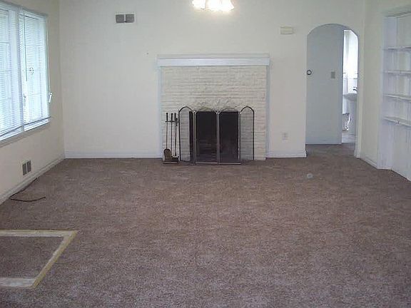 Living Room w/ Ceiling Fan and Fireplace