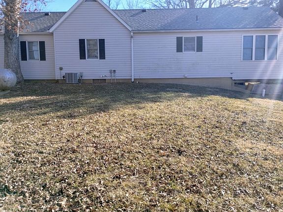 THIS IS THE REAR OF THE HOUSE. YOU CAN SEE THE PROPANE TANK ON THE LEFT SIDE.