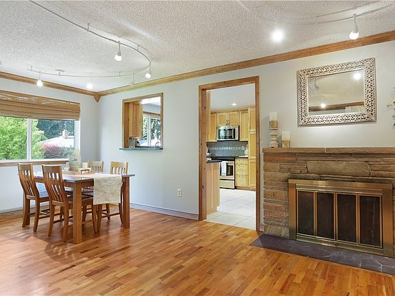The dining room pass through between the kitchen makes for easy access when entertaining. Hardwood floors make the space feel warm and inviting!