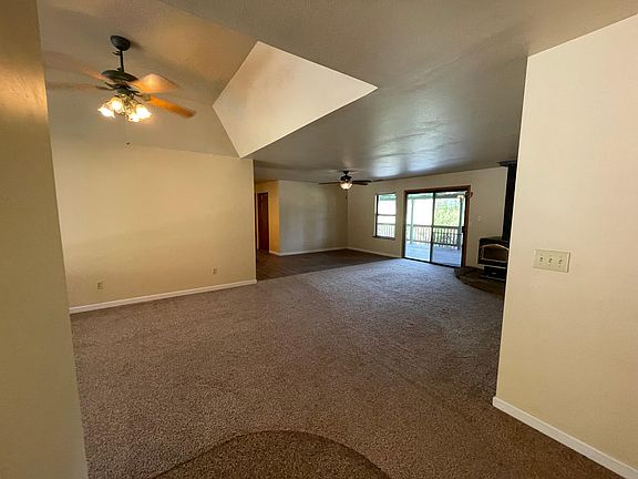 Entryway opens to formal dining room and living room to the left and hallway to bedrooms to the right.
