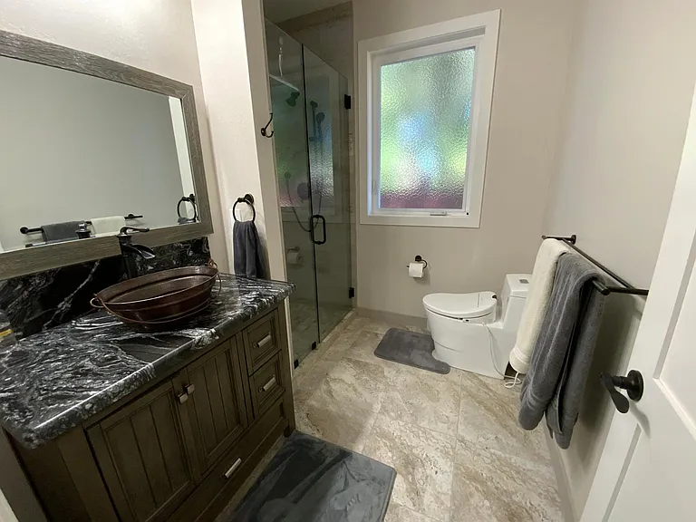 Luxury large bathroom with Bidet, Rain Shower with handheld wand, foldable teak bench, copper vessel sink