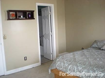 Large Master Bedroom : Walk-in closet, private bath, and new ceiling fan. Brightly lit with two wind