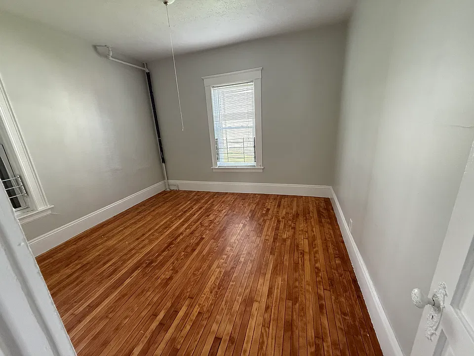 Bedroom with refinished hardwood floors.