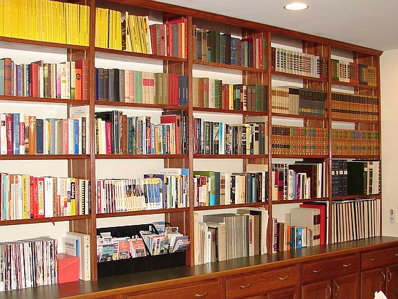 Bookshelves over cabinets in family room
