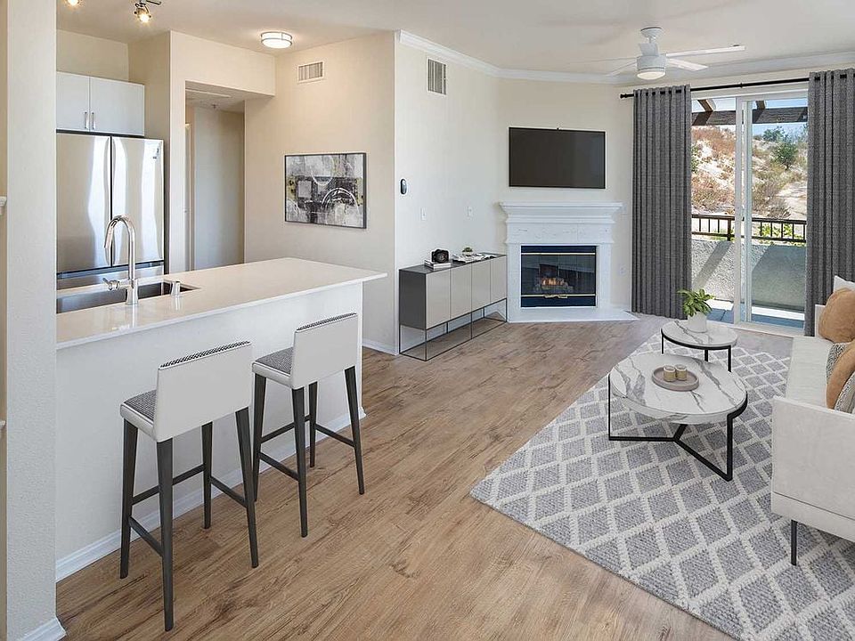 Renovated Package I kitchen and living room area with open concept floor plan, fireplace, and hard surface flooring