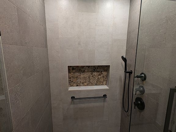 Walk-in shower with heated floor.