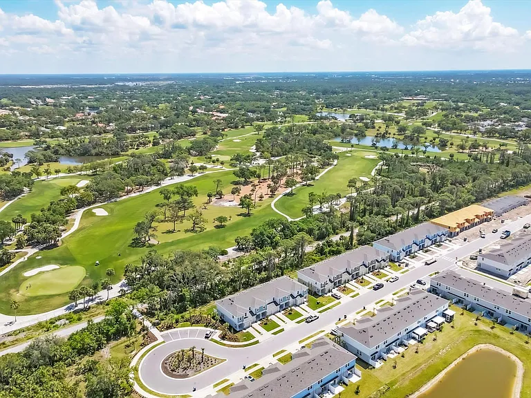 Legacy trail behind. Unit 2nd from Left. Guest Parking to left. Community Legacy Trail Gate to left of guest Parking. Golf course behind legacy trail.