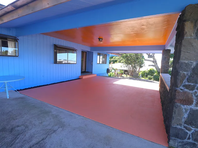 large porte cochere with entrance to living room and circular driveway