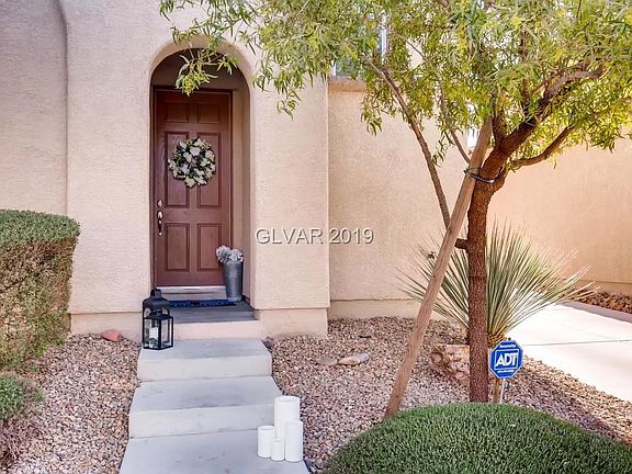 Beautiful entrance to the home from the street.  Plenty of off street parking in the driveway leading to the 2 car garage.