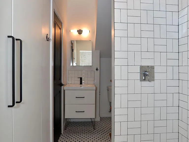 White tiled bath with integrated closet