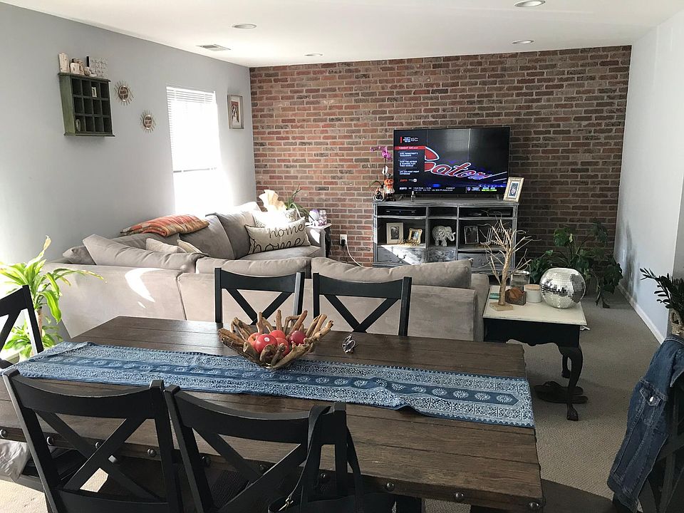 Open living space with exposed brick wall.