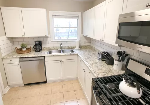 The custom-built kitchen has everything you need to feel at home including a gas range, dishwasher, cookware, and all other kitchen essentials. - 3607 Kell St