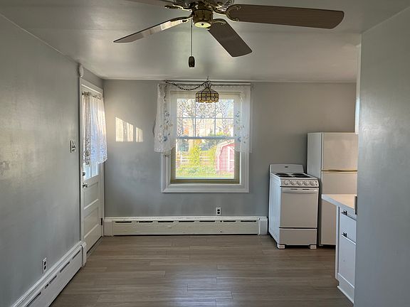Living room view towards entrance & kitchen nook