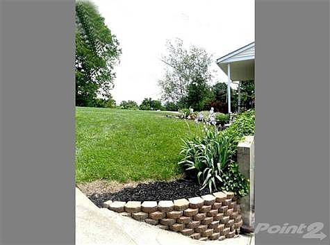 Landscaping wall by driveway.