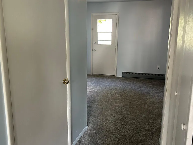 Hallway from LV to DR with storage closets on either side