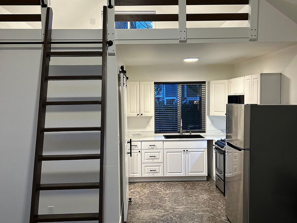 From the living room, you are able to see up to the loft and straight into the kitchen.