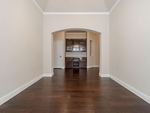 View from dining room to the hall way and built-in hutch for dinning room cupboard and storage