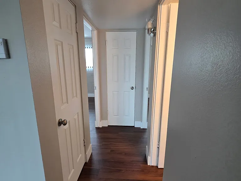 both coat closet and linen closet in hallway