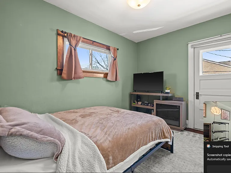 Bedroom 3 has access to the laundry porch overlooking the back patio.