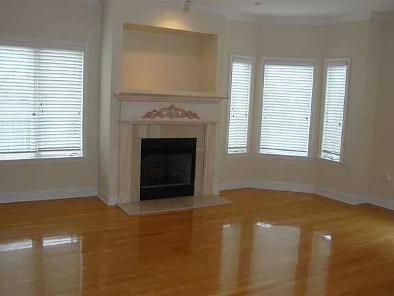 Spacious open floor plan with gleaming hardwoods and gas log