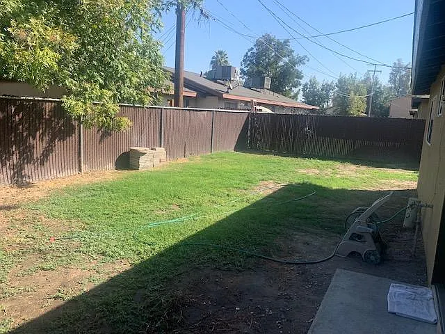 backyard, goes around to right where garage access is located and side gate