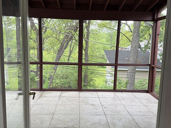 Serene covered balcony for outdoor entertainment.