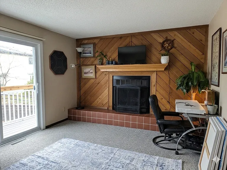 The living room also features a cozy fireplace!